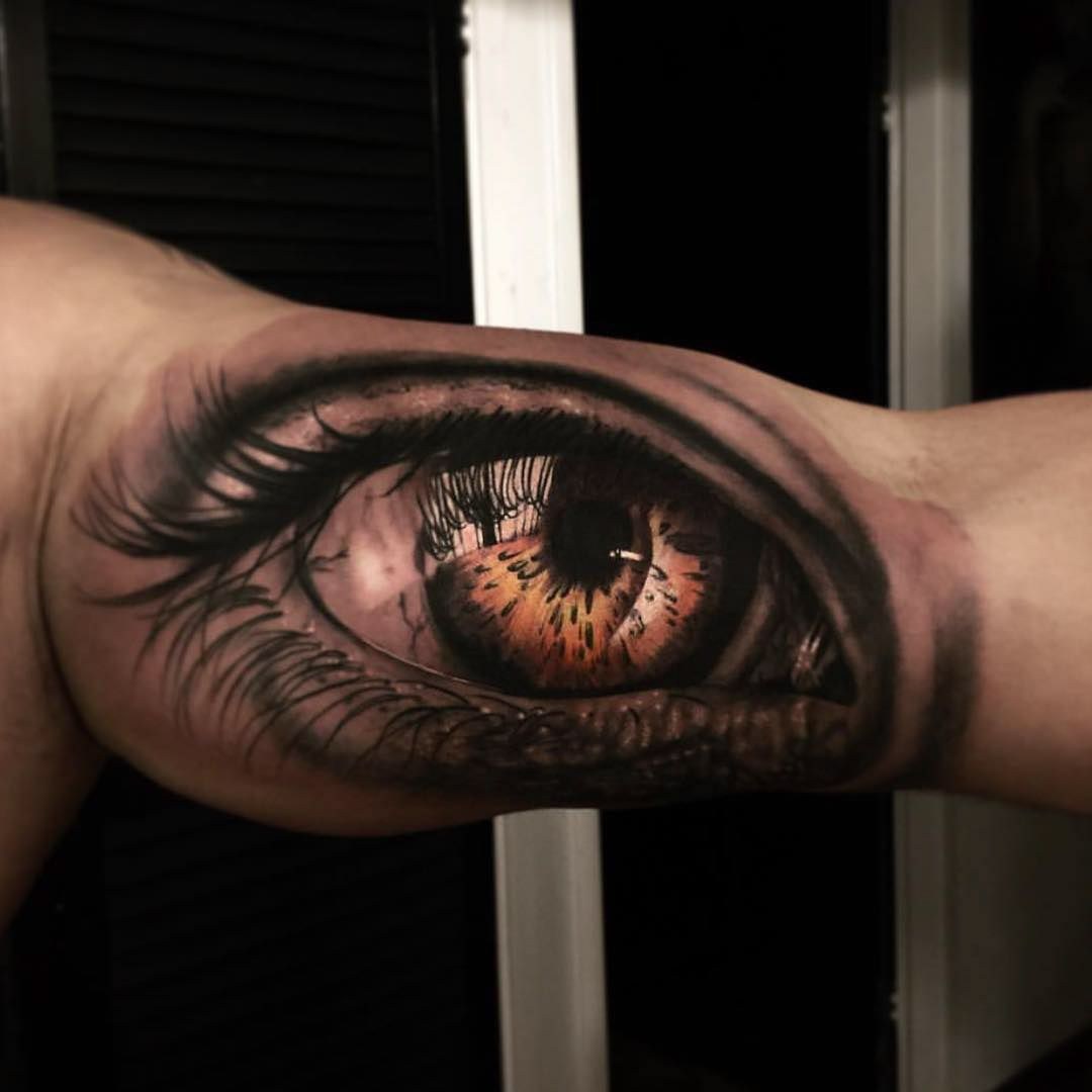colored eye inner bicep tattoo for men
