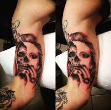 dead woman face inner bicep tattoo for men