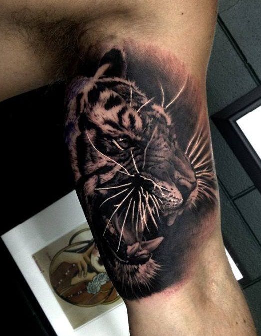 detailed tiger face inner bicep tattoo for men