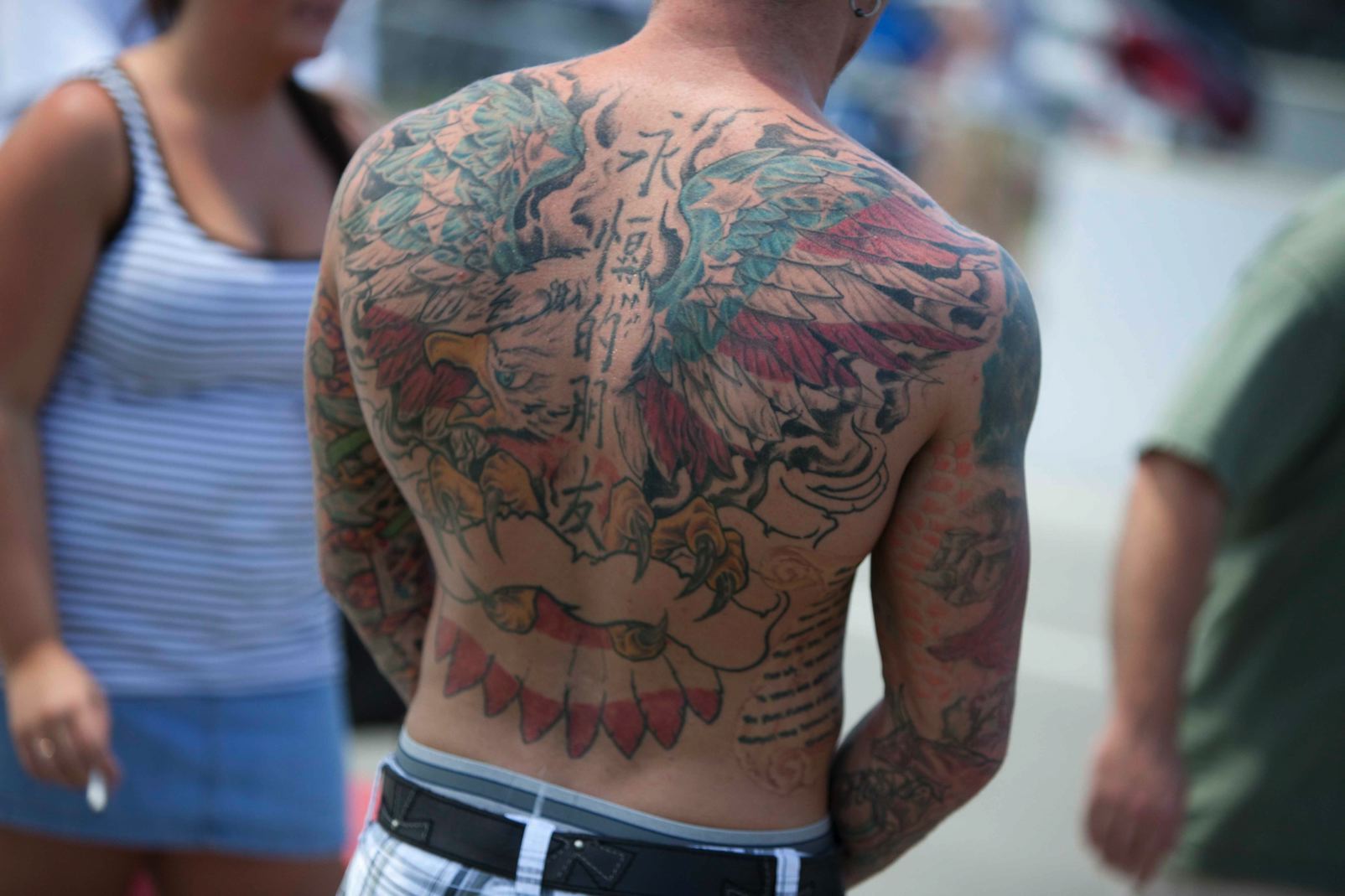 feathered wings back tattoo for men