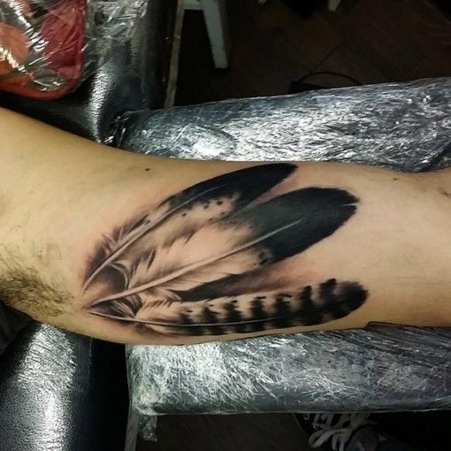 feathers inner bicep tattoo for men