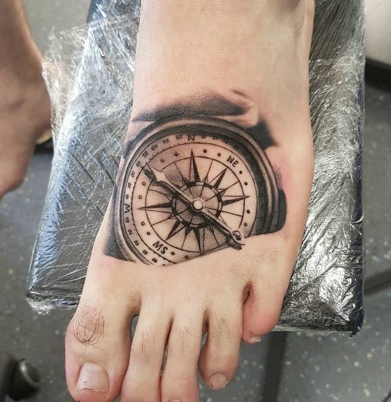 foot compass tattoo for guys