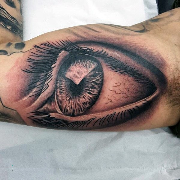 gazing eye inner bicep tattoo for men