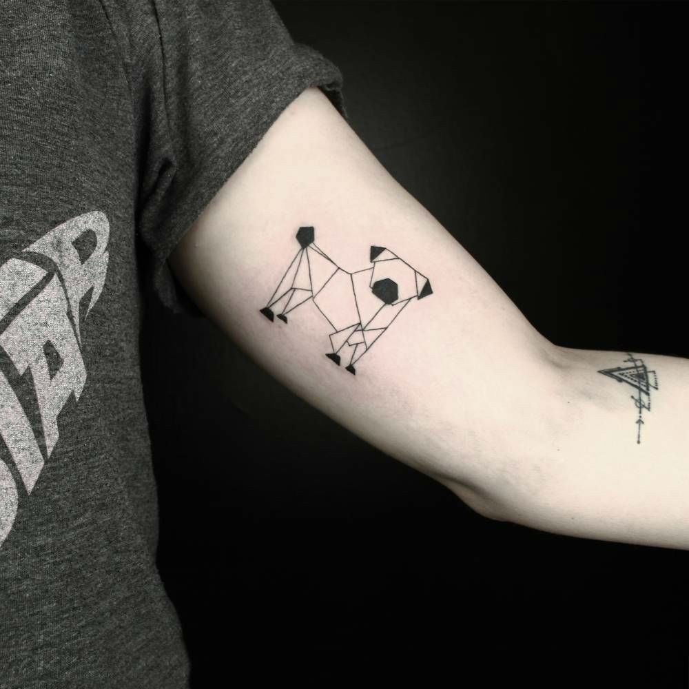 geometric dog inner bicep tattoo for men