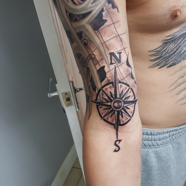 map and compass inner bicep tattoo for men