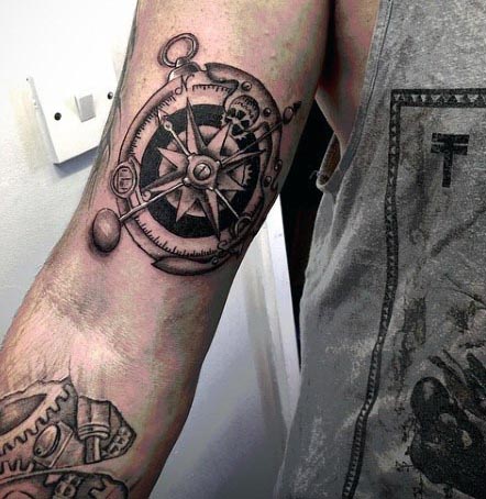 metallic compass inner bicep tattoo for men