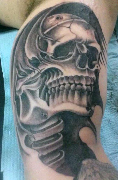 skull and spine inner bicep tattoo for men