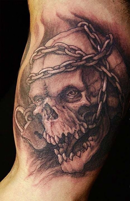 skull in chains inner bicep tattoo for men