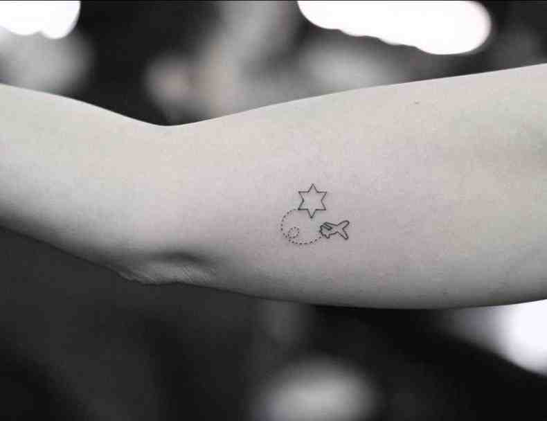 star and fish inner bicep tattoo for men