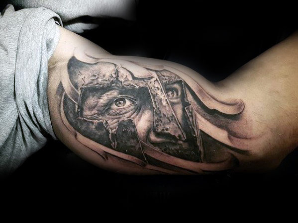 warrior face inner bicep tattoo for men