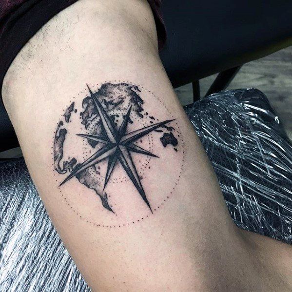 world and compass inner bicep tattoo for men