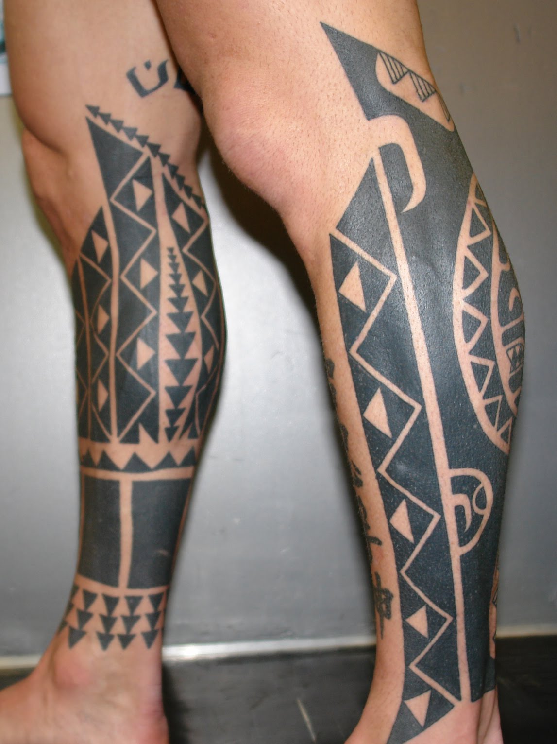 matching tribal aztec leg tattoo for men