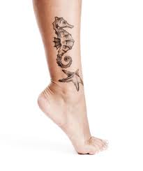seahorse and starfish leg tattoo for guys