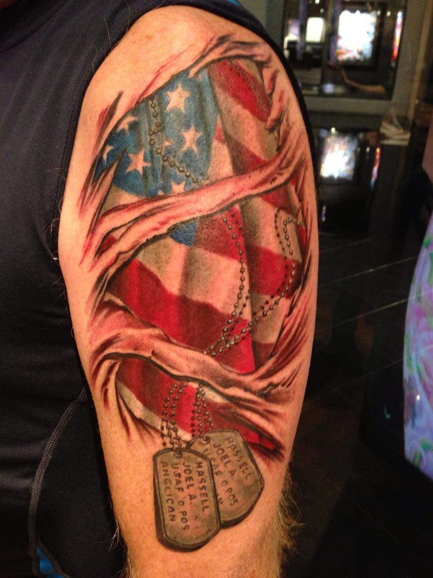 dog tags hanging from american flag tattoo for men