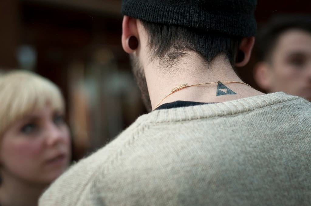 simple triangle neck tattoo for men