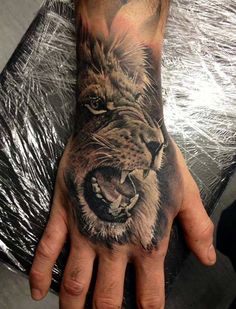 lion back of hand tattoo
