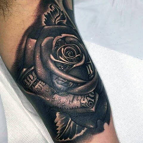 bicep-black-ink-heavily-shaded-money-rose-tattoo-design-for-guys