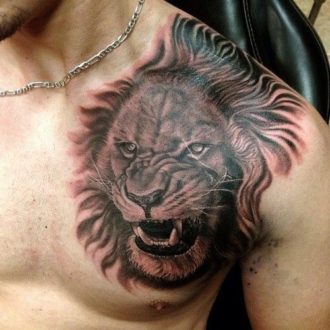 chest and shoulder lion tattoo