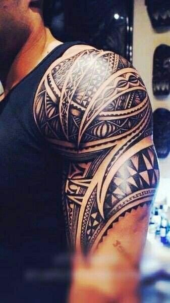 tribal style tattoo half sleeve on arm