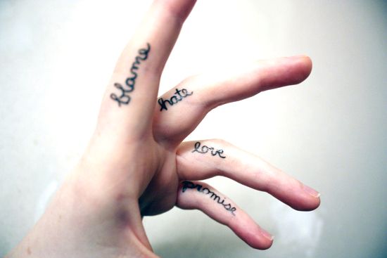 contrasting message finger tattoos for men