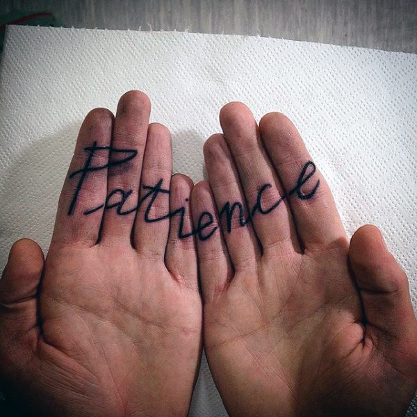 cursive patience finger tattoos for men