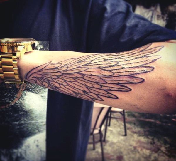 detailed forearm wing tattoo for men