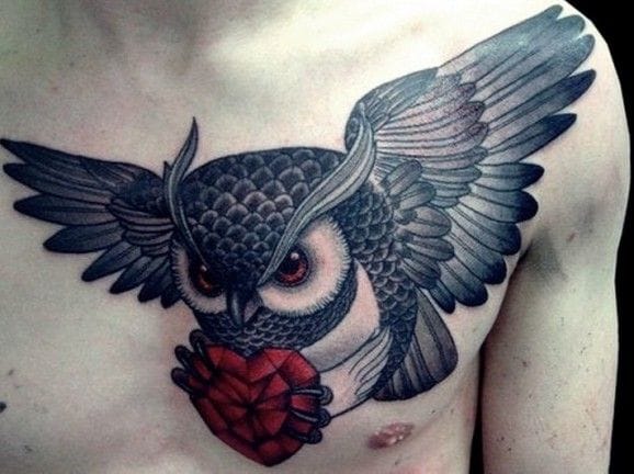 flying owl carrying heart men's chest tattoo