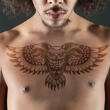 flying owl men's chest tattoo