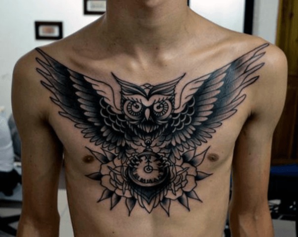 flying owl with clock and roses men's chest tattoo