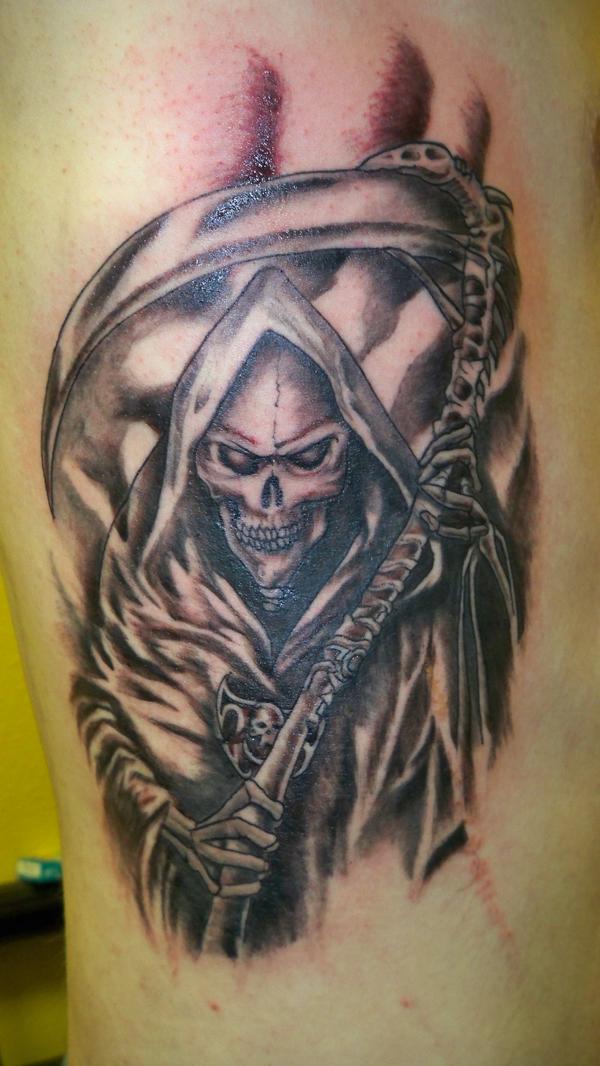 sick grimacing grim reaper tattoo for men