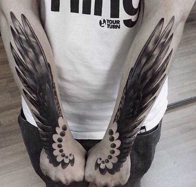 interesting forearm wing tattoo for men