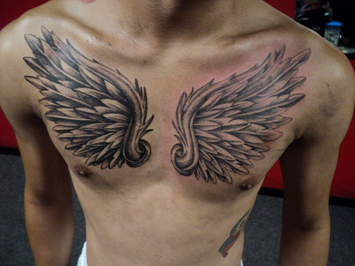 interesting wing tattoo for men's chests