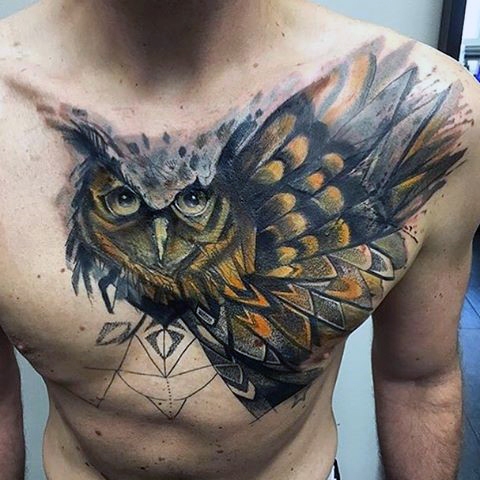 owl taking off for flight men's chest tattoo