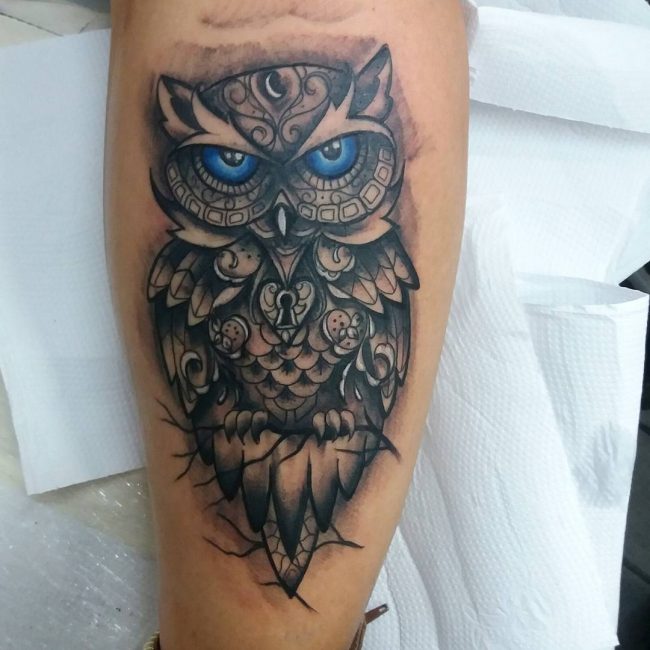 owl with lock design men's arm tattoo