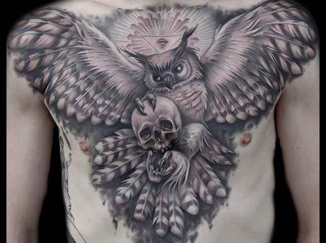 owl with talons in skull men's chest tattoo