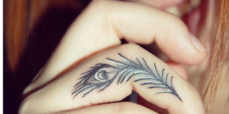 peacock feather finger tattoo for men