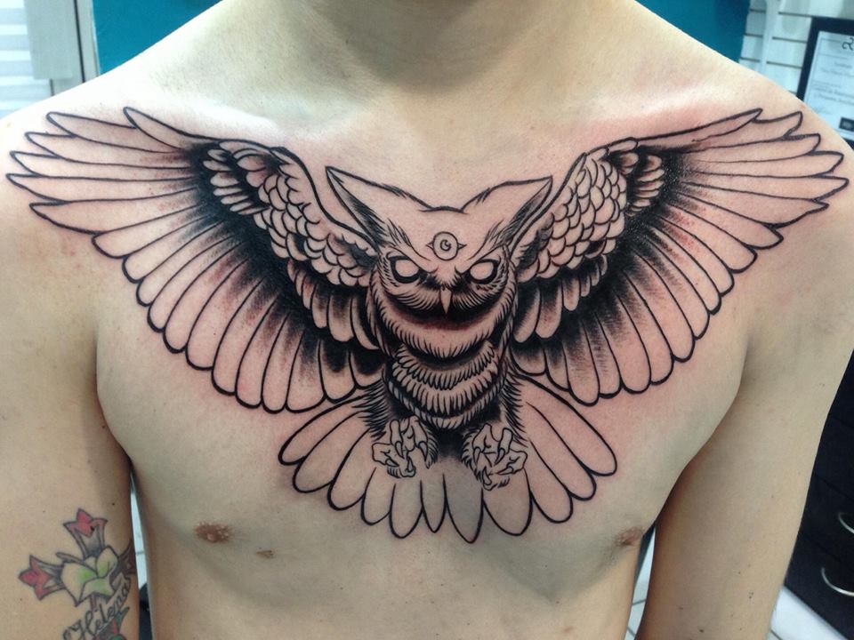 runic flying owl men's chest tatoo