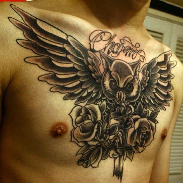 spread wing owl with roses men's chest tattoo