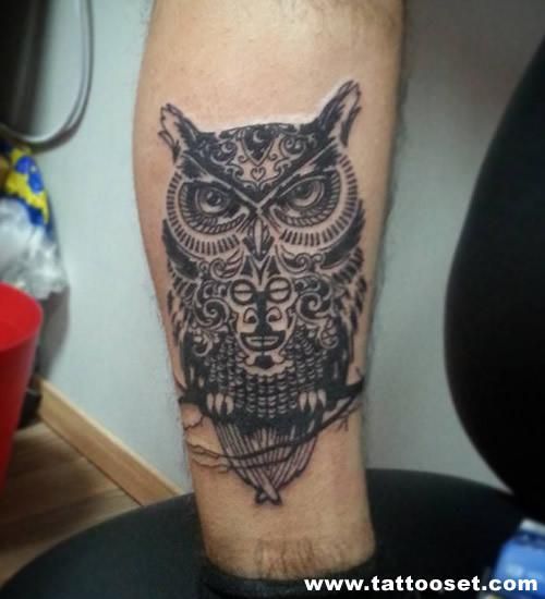 totem owl on branch men's inner arm tattoo