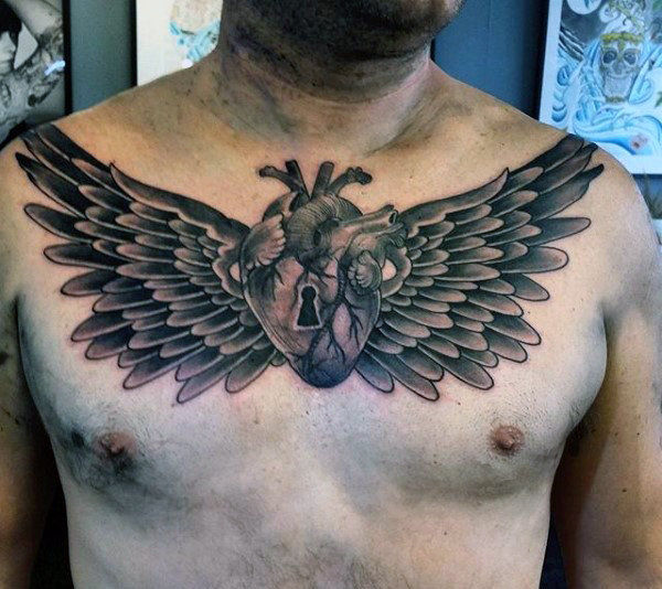 wings with beating heart and keyhole tattoo for men