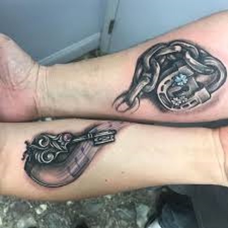 chain and lock matching couple tattoo