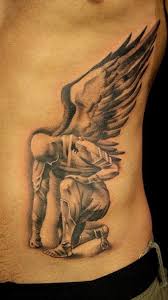 kneeling guardian angel tatoo for men