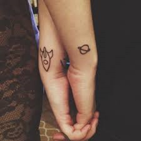 rocket and planet matching couple tattoo