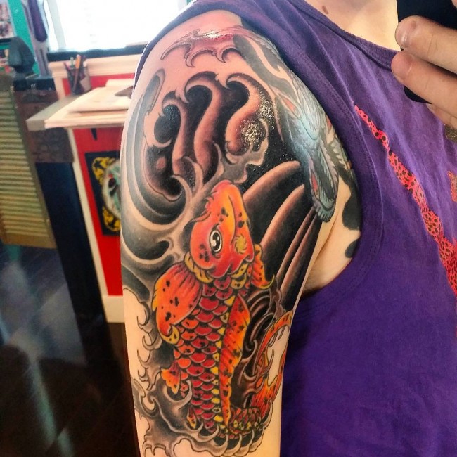 Colored Koi Fish Against Black Water Tattoo
