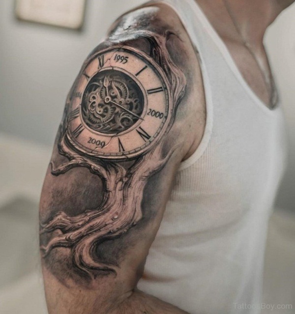 Shoulder Tattoo of a Clock Growing from a Tree