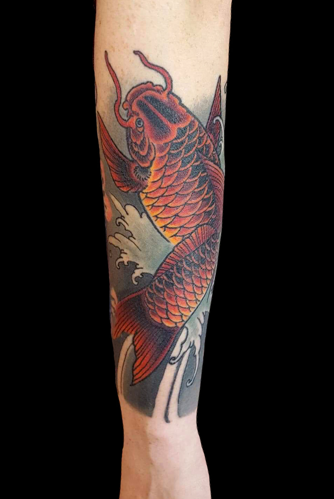 Subtle Red and Orange Koi Fish on Your Forearm