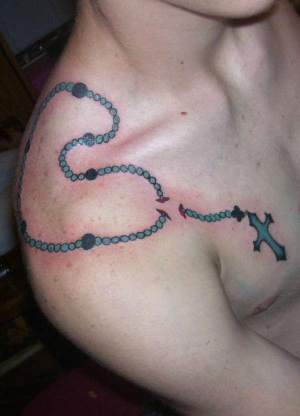 Blue and Navy Shoulder Through-the-Skin Rosary Tattoo