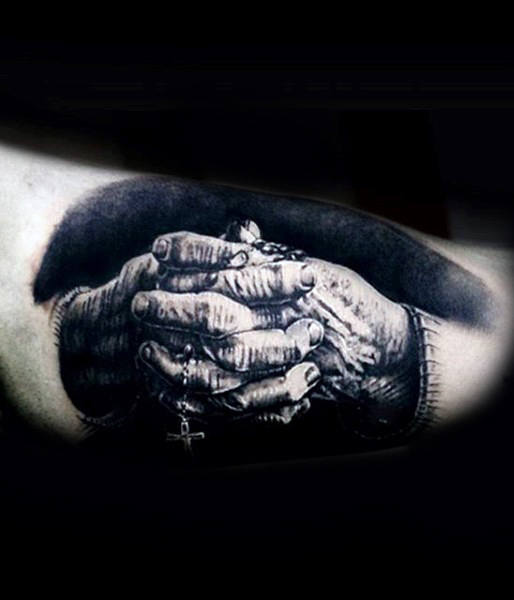Realistic Tattoo of Two Hands Holding a Rosary