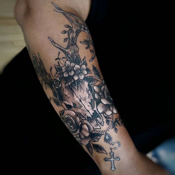 Rosary Tattoo that Incorporates Flowers and a Deer's Skull
