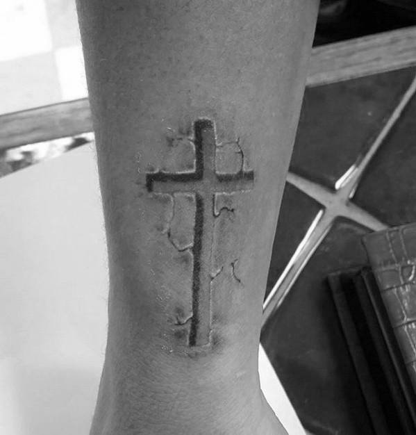 Tattoo of a Cross Tearing Through Skin